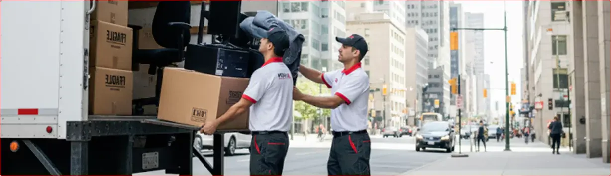 Professional movers carefully handling furniture